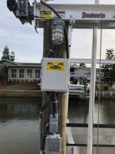 A GEM boat lift remote control with auto-stop feature set-up for a boat lift