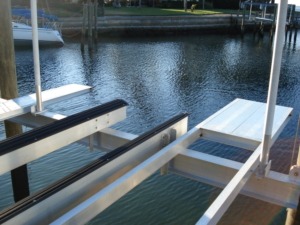 An aluminum stern platform and set of bunks installed on a boat lift