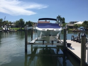 An aluminum direct drive boat lift with an aluminum walkboard attached